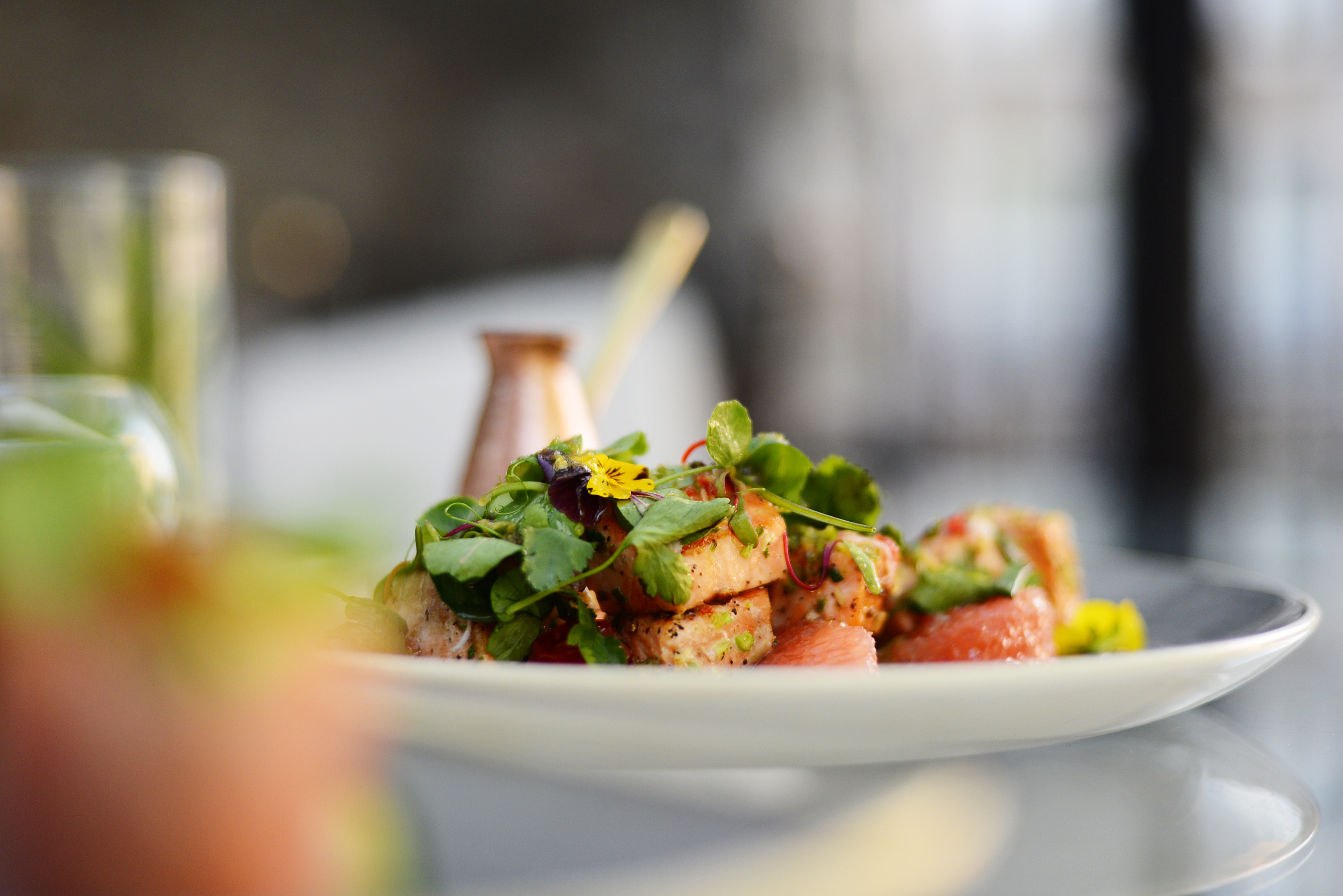 Plate adorned with vibrant salad, greens, and flowers, Dining at Banyan Tree Puebla.